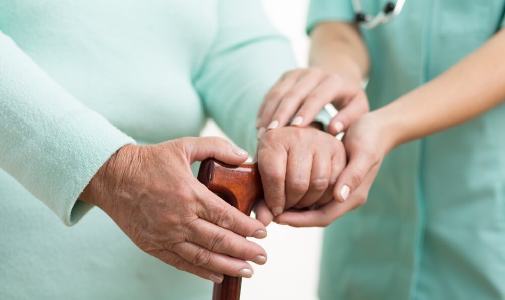 Carers' hand on Elderly Woman