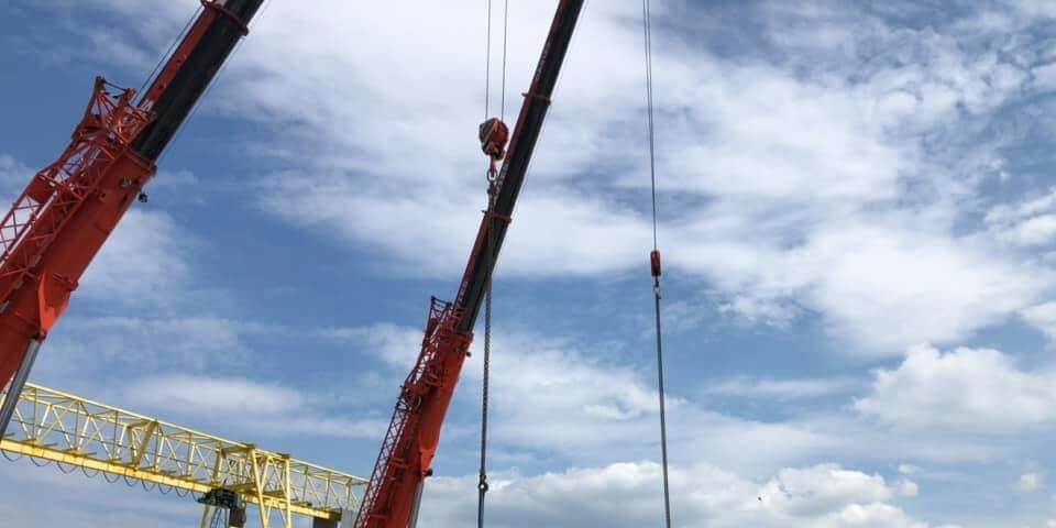 Two Crane Lifting Materials off a Boat