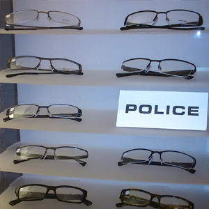 A clcse up of a stand containing Police brand glass frames