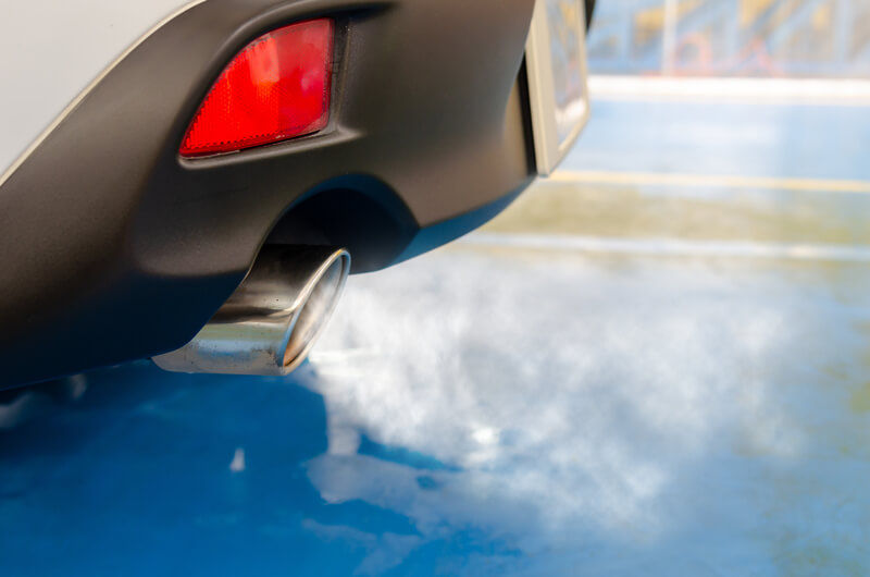 Car exhaust billowing white smoke
