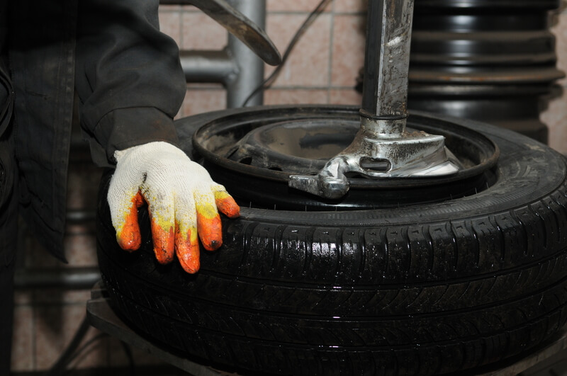 Taking off tyre from car wheel disc for repair