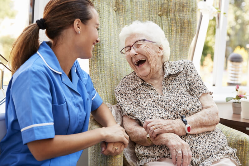 Carer laughing with Elderly Woman