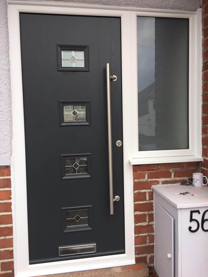 Front of house grey composite door with windows and sidelight