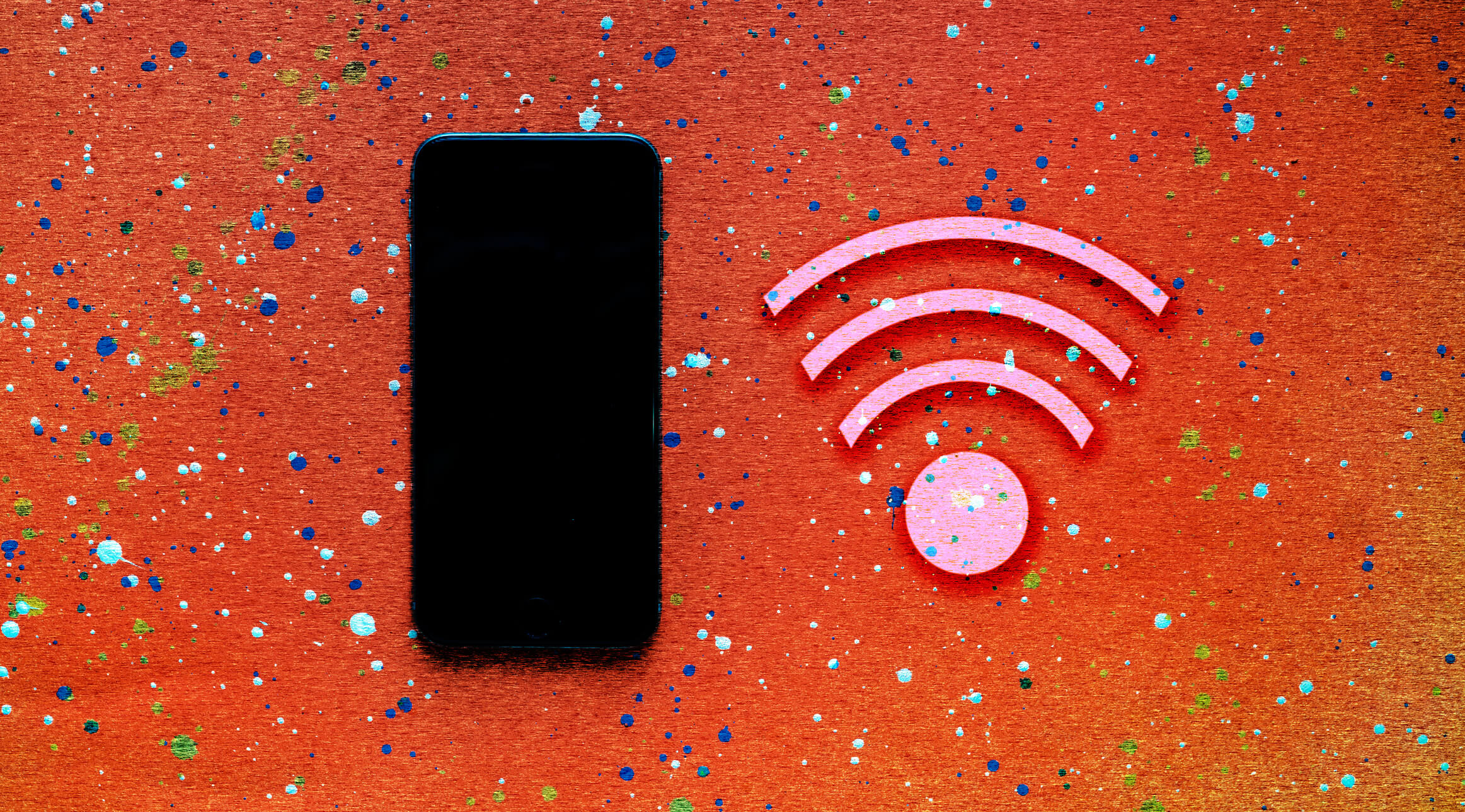 A black smartphone on color background with a wi-fi signal icon, web communication concept.