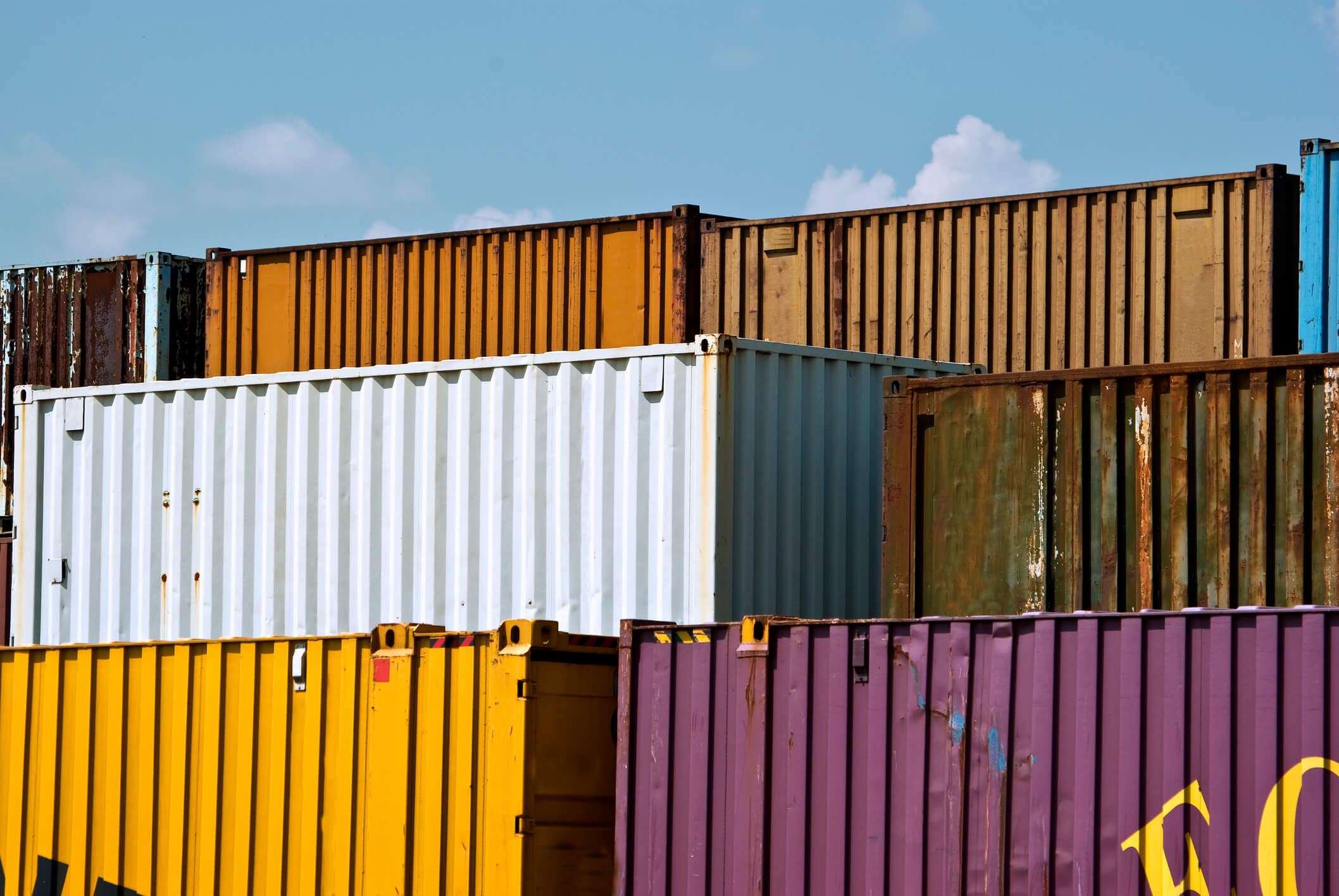 Freight containers stacked in various colors for shipping