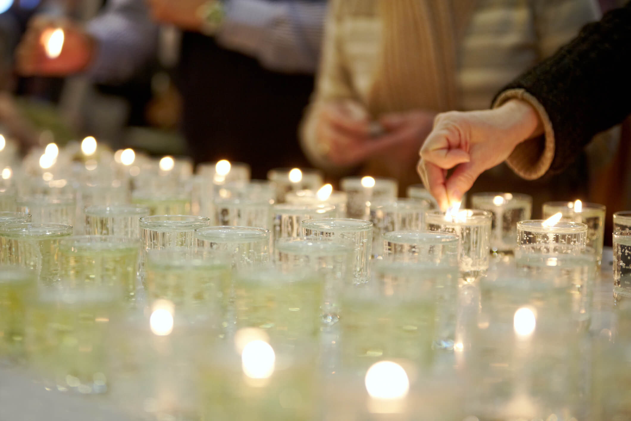 Lighting candles as part of traditional funeral service