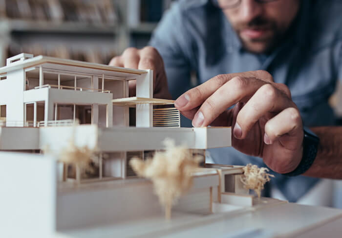 Man building architectural model of a house