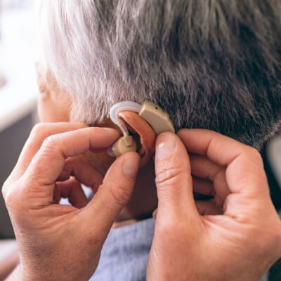 Otolaryngologist putting a Hearing aid in