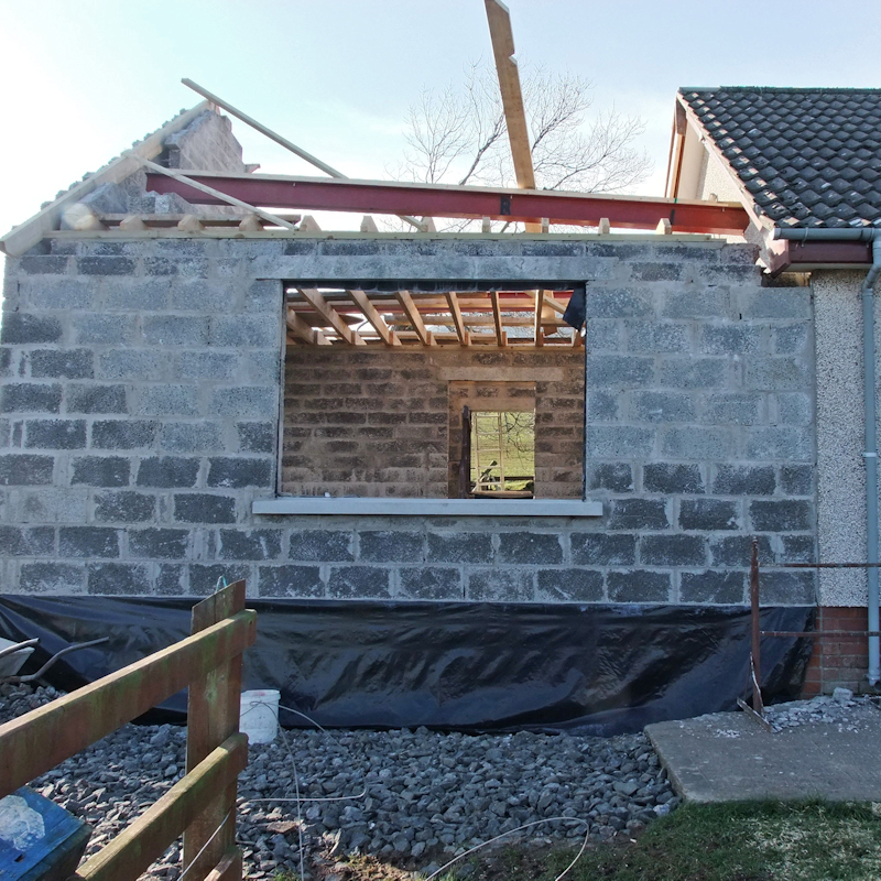 Building an extension to a house home with blocks, concrete bricks and timber bungalow