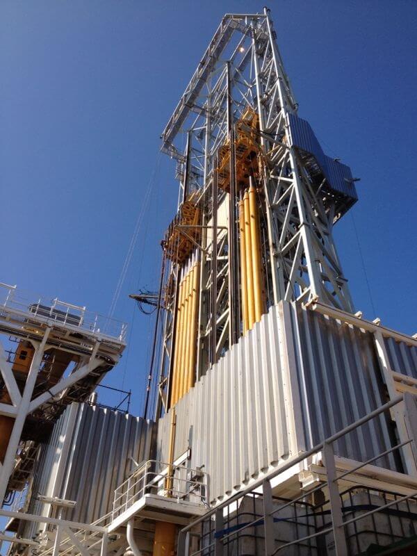 Tall metal rig in a workyard.