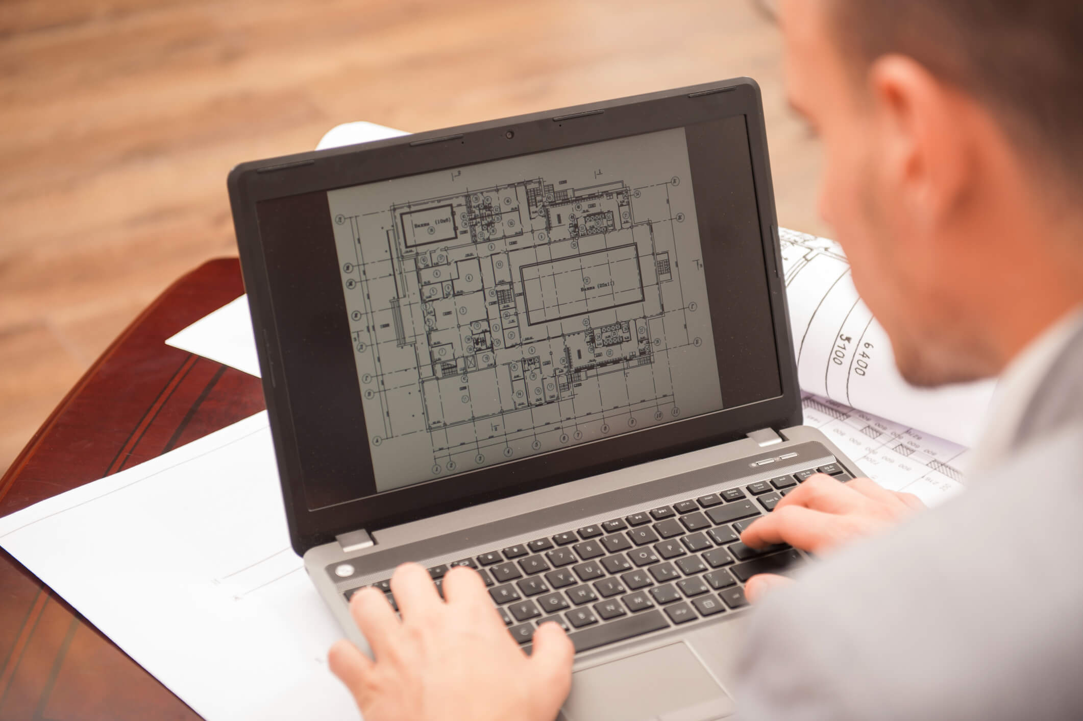 Over shoulder view of a laptop screen showing CAD drawing