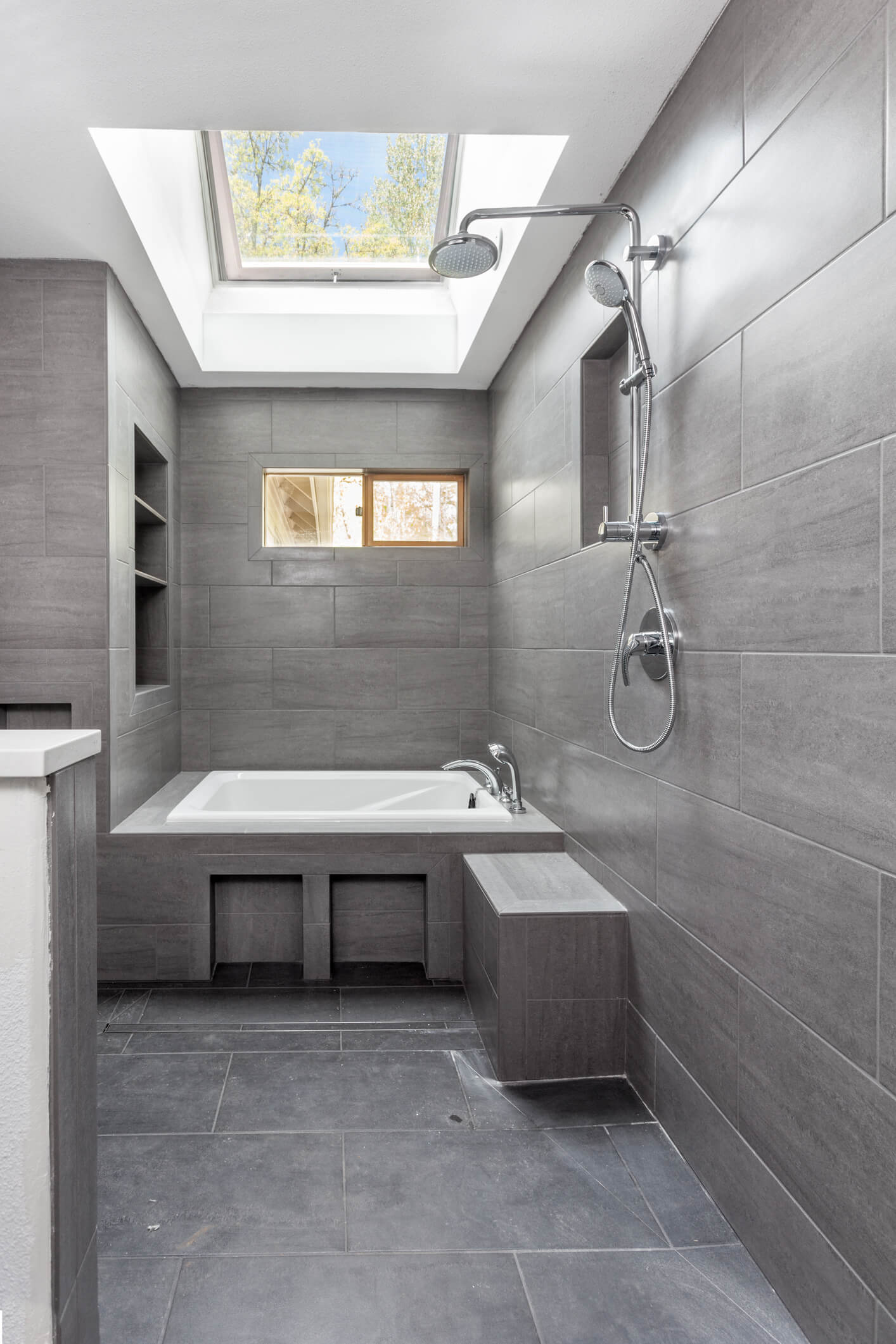 Sleek, modern wetroom installation with bath, shower and sink