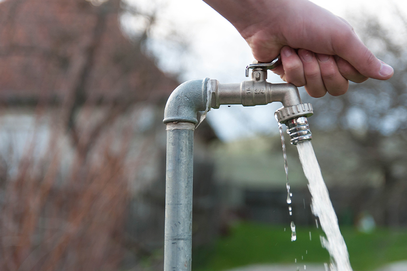 Garden water tap, pouring clean fresh water