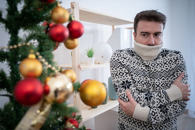 cold man with christmas tree