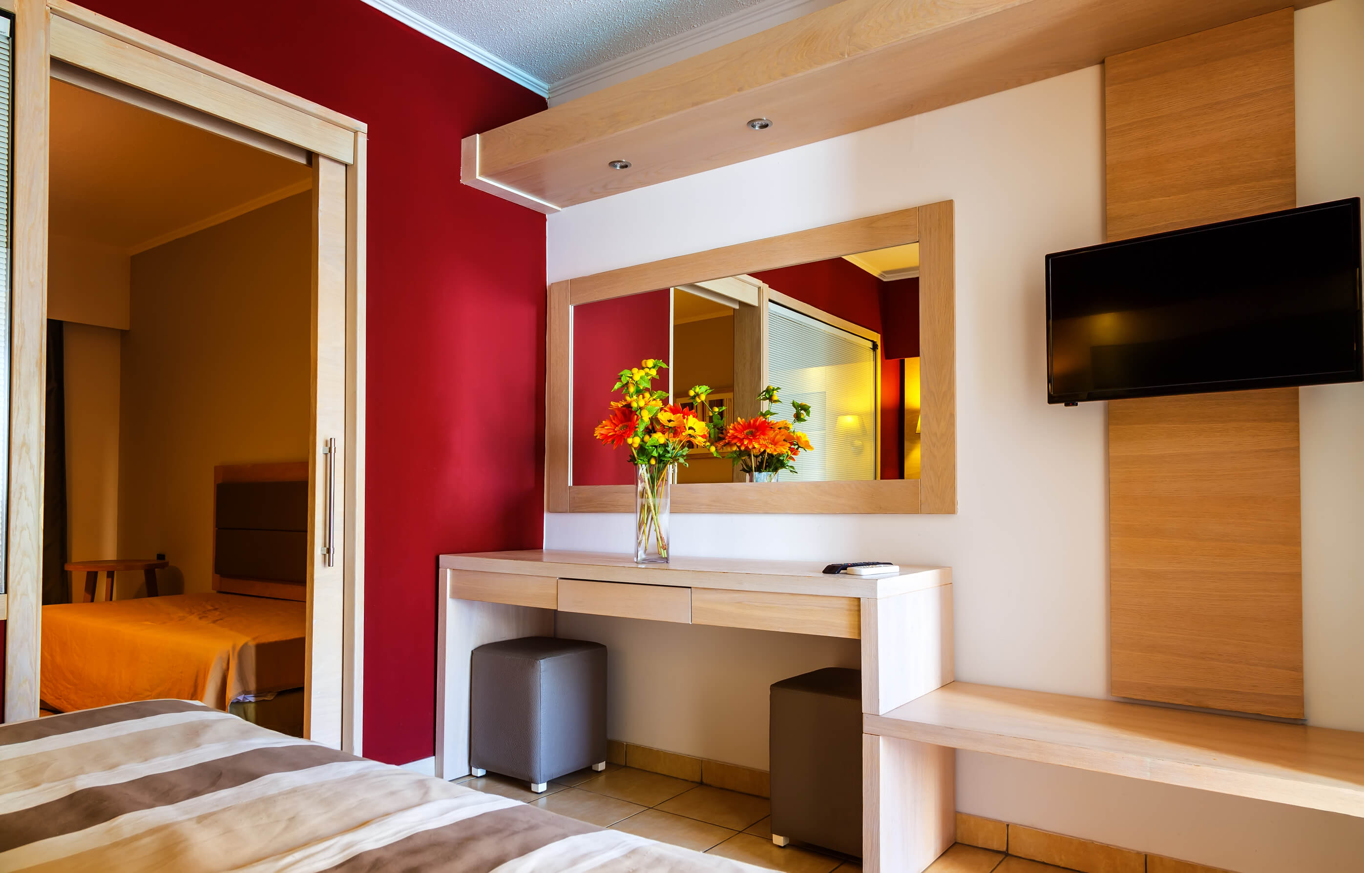 Luxury modern hotel room interior details. mirror and vase of flowers on the table.