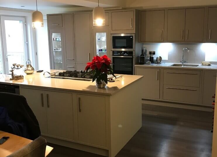 white and grey kitchen design with flowers on new worktop