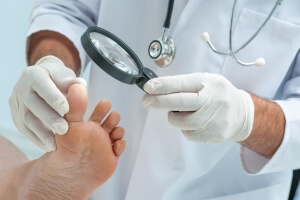 Chiropodist inspecting a fungal condition