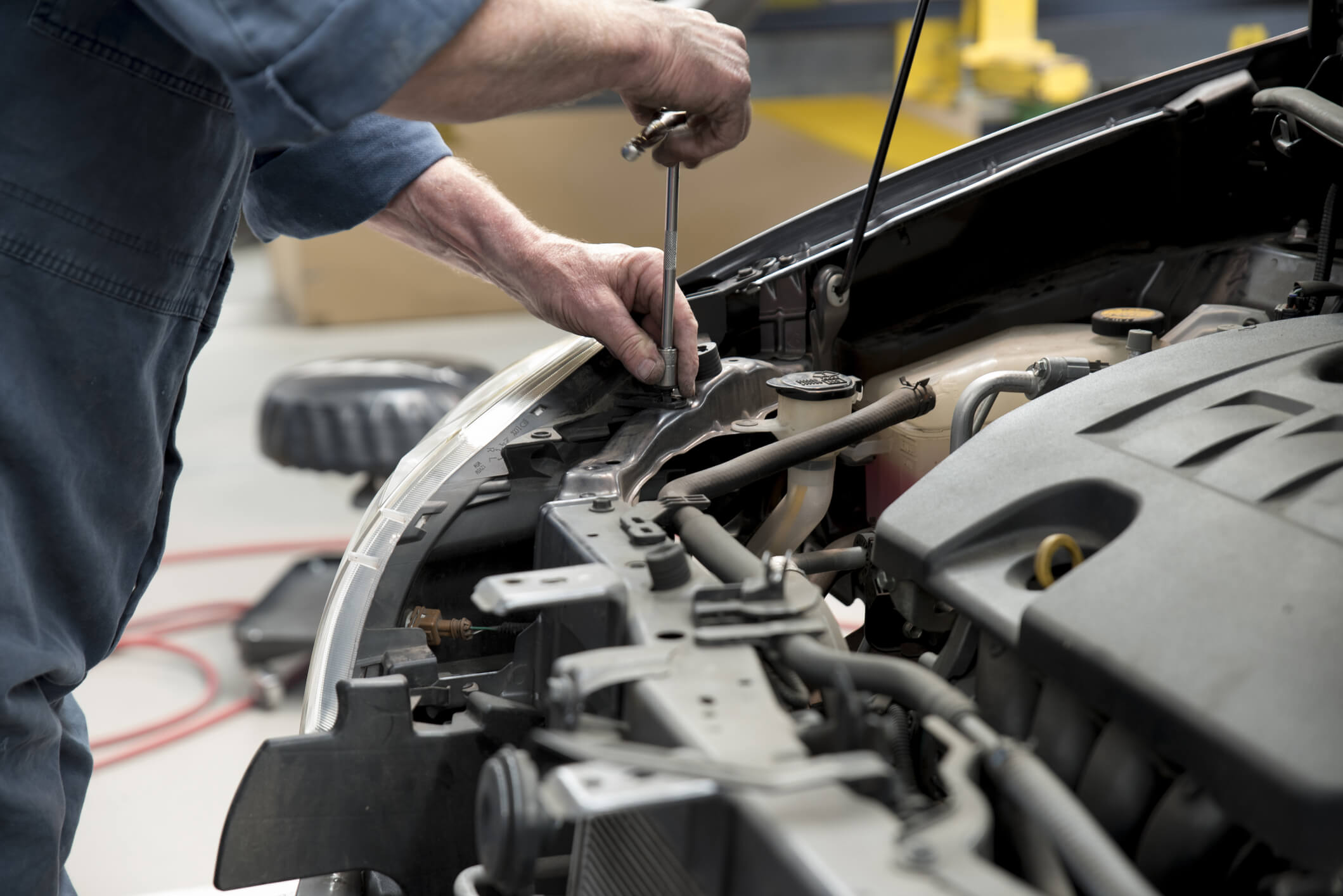 Close up of a motor car mechanic in panel repair shop