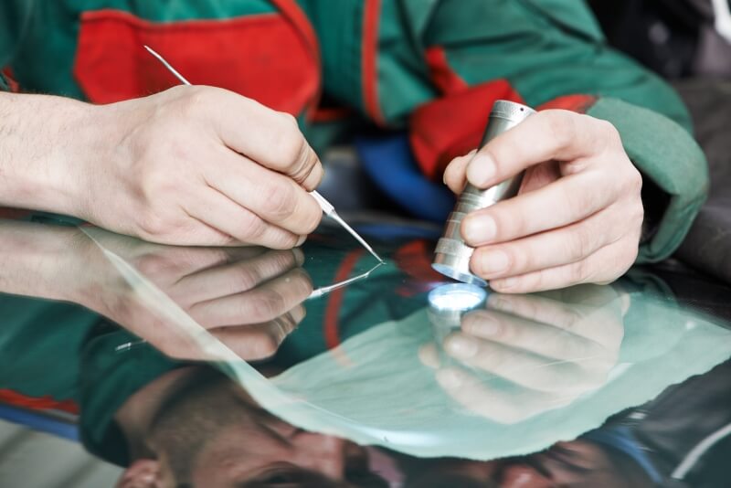 Technician fixing windscreen