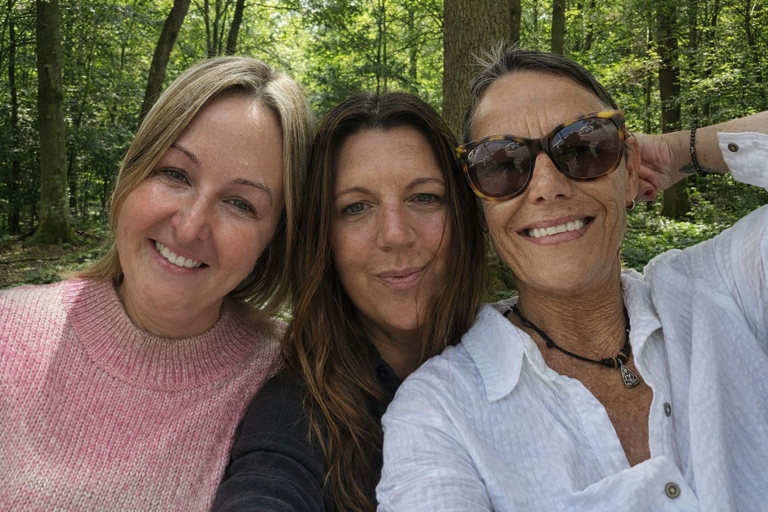 Three women smiling tat camera