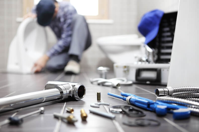 Plumber working on a Toilet