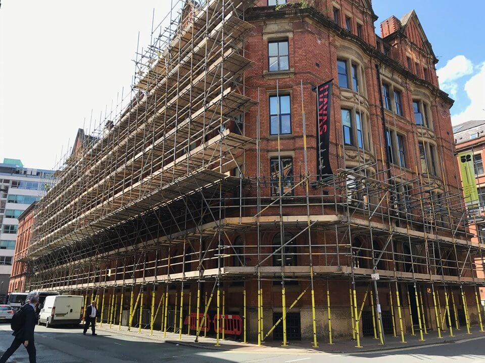 scaffolding around a large brick building