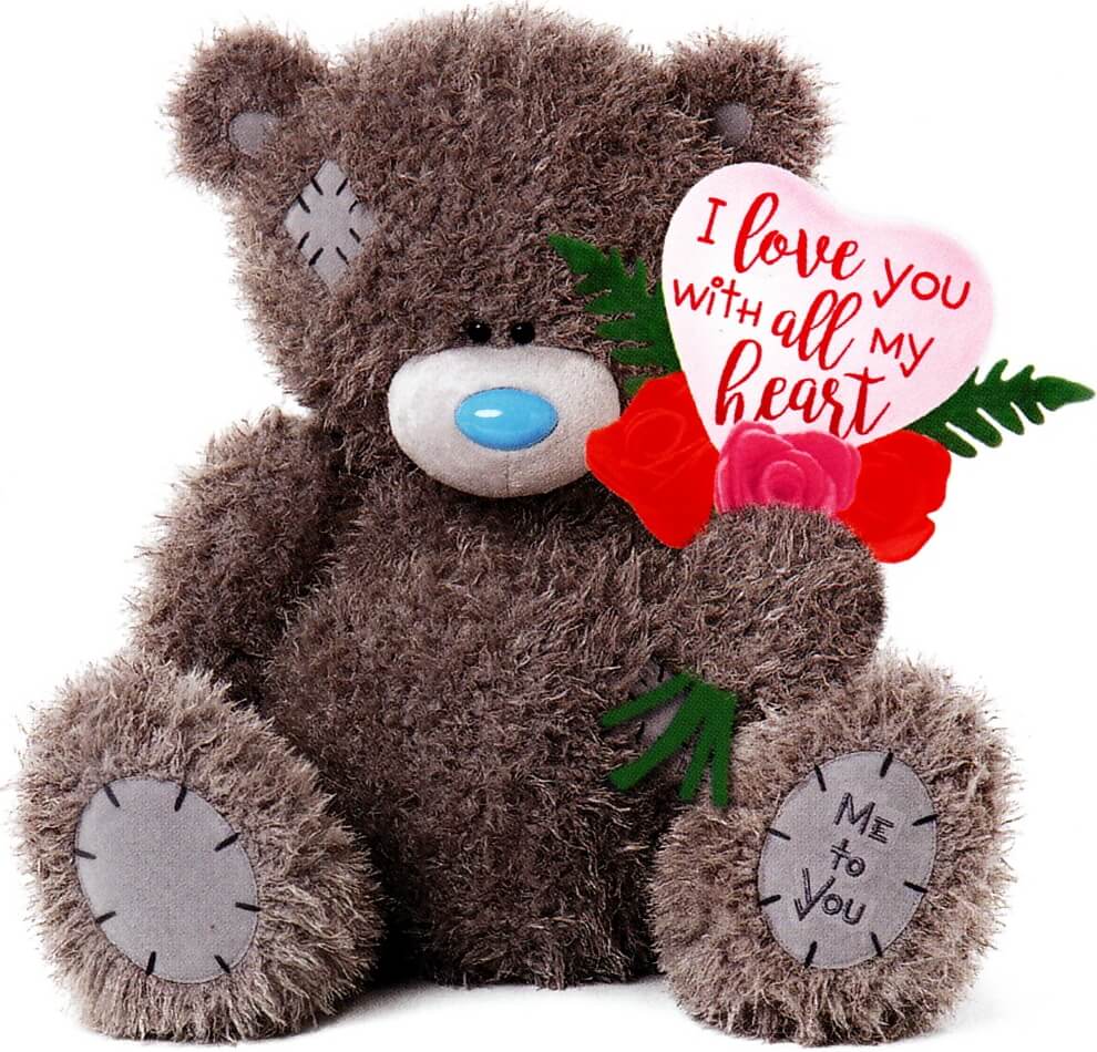 Teddy bear holding a pink heart and roses