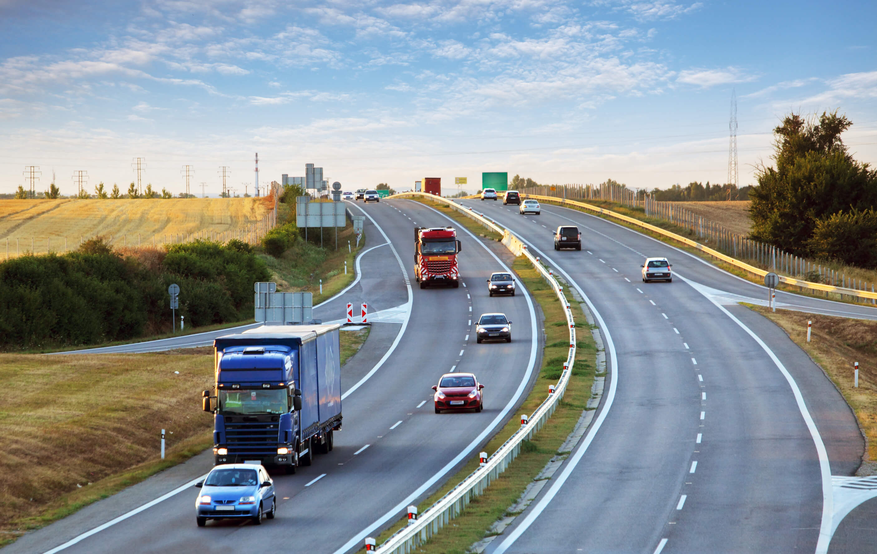 view of car and trucks driving on motorway