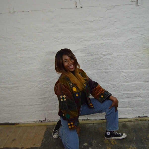 Woman taking the knee in baggy blue denim jeans