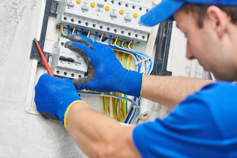 Electrician connecting and assembling power cable into switchboard equipment