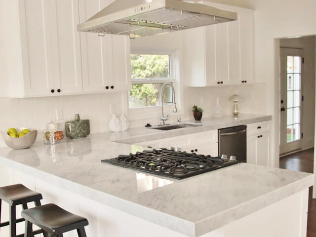 White kitchen with carrara marble countertops