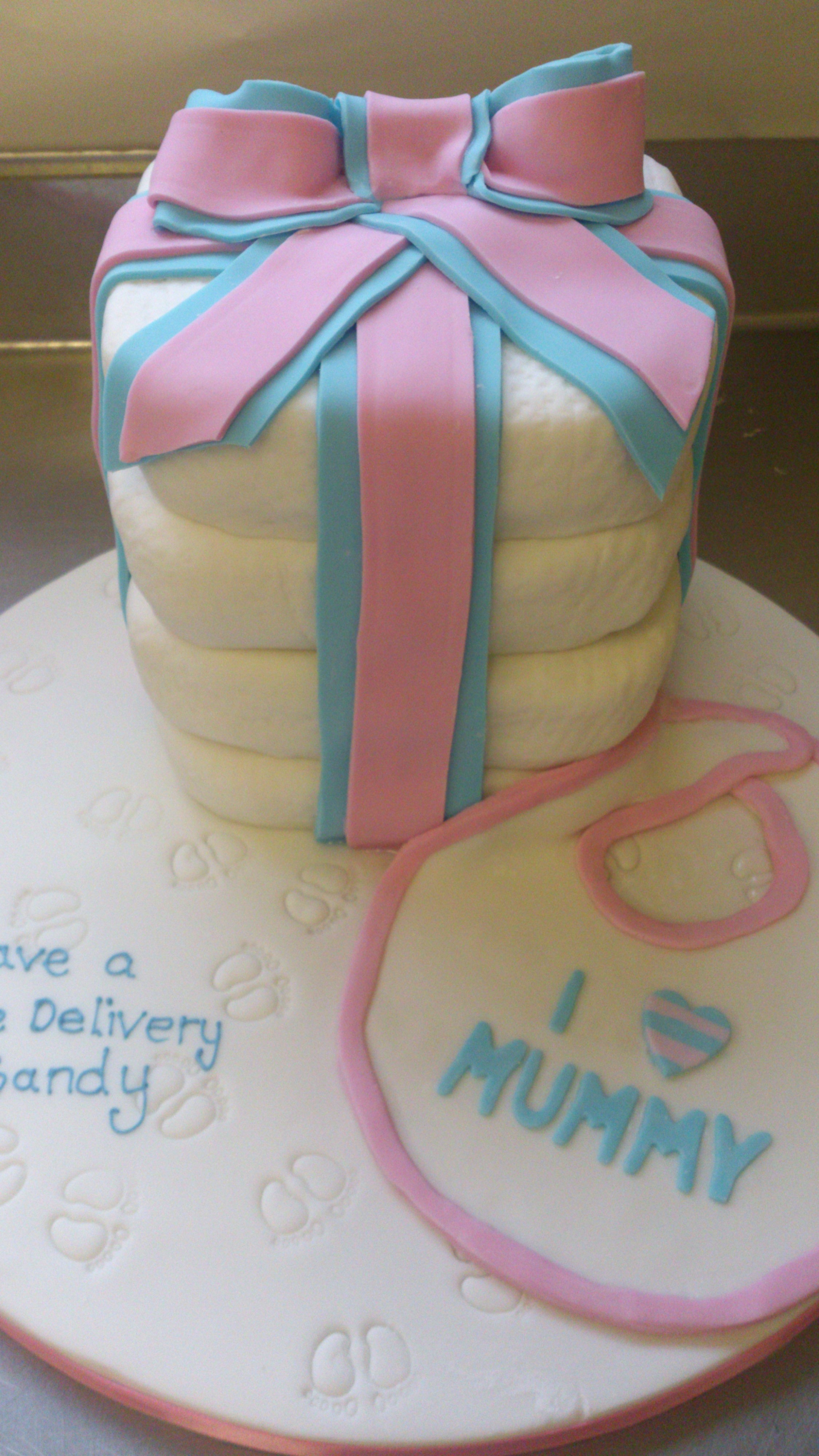 A cake in a the shape of nappies