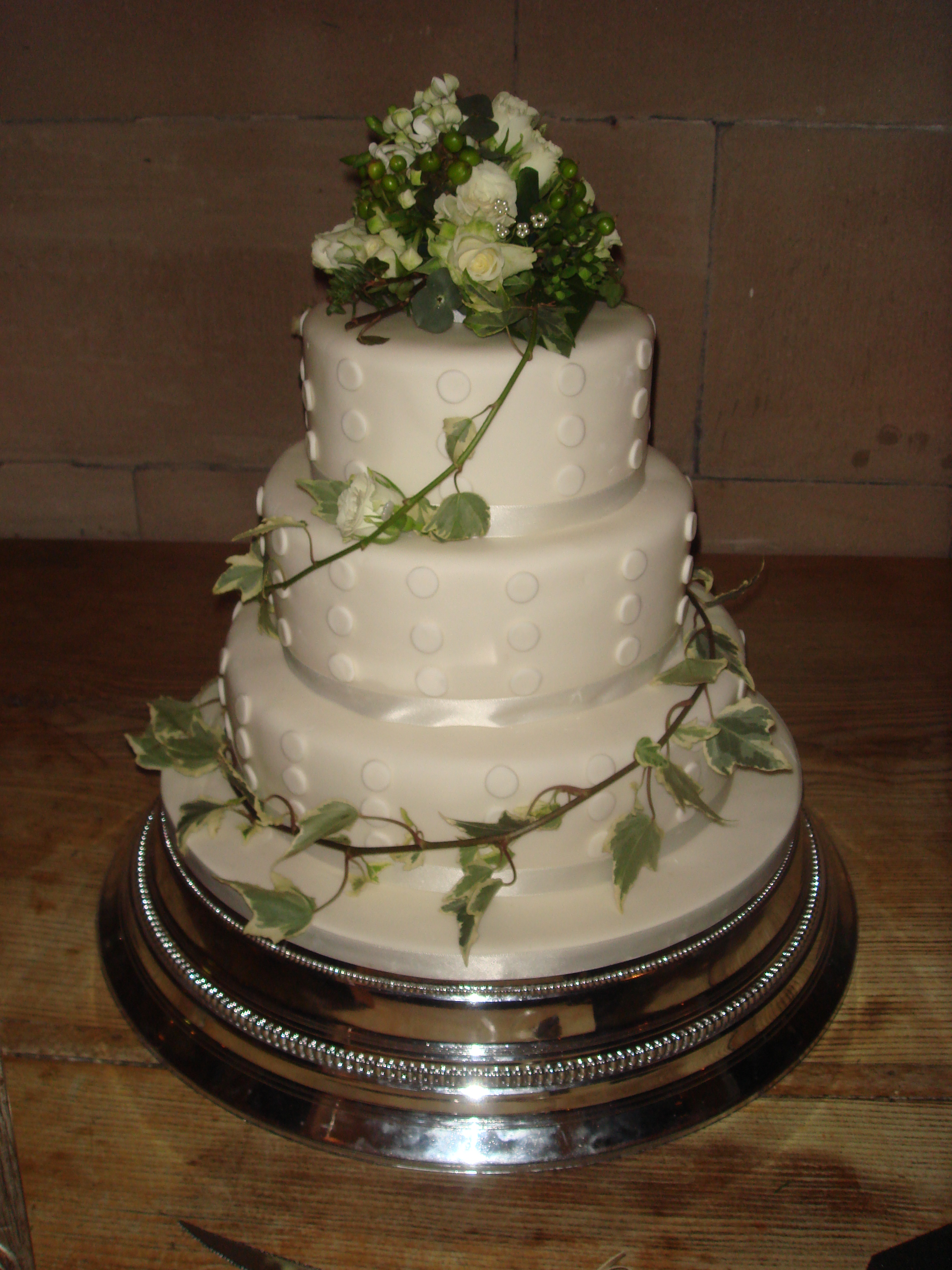 A white wedding cake with flowers on it
