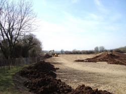 Here we are using the bulldozer to spread the large topsoil heaps in the middle of the site and loading a more awkward pile with the excavator and dumper...