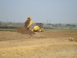 Tipping topsoil on the bunds, just about wide enough to get the dumper along it...