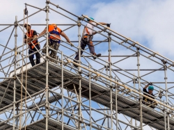 Builders working on a building with scaffolding