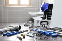 Plumber tools and equipment in a bathroom