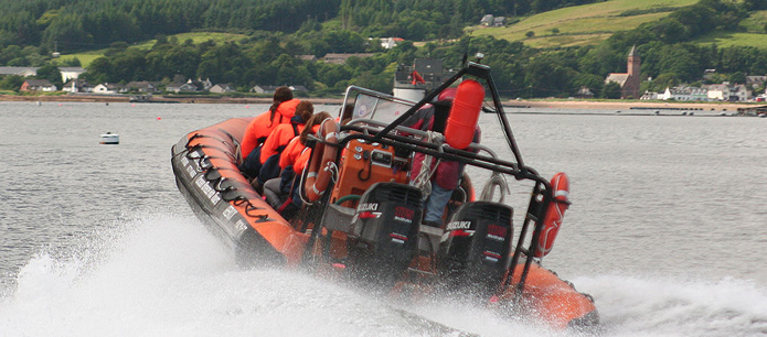 A group boating on the Isle Of Arran waters