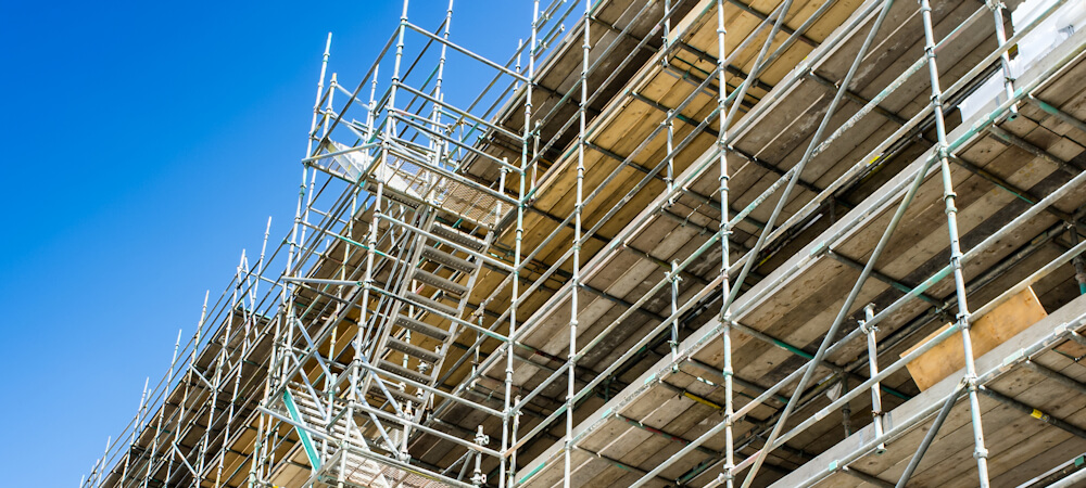 Scaffolding against a building with blue sky
