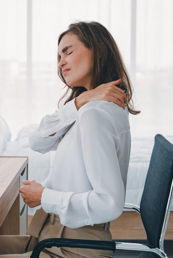 Young woman neck and shoulder pain injury with red highlights on pain area