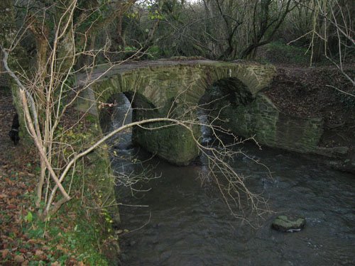 Old stone bridge crosses over river