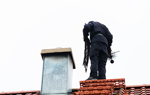 Chimney Sweeper On Roof