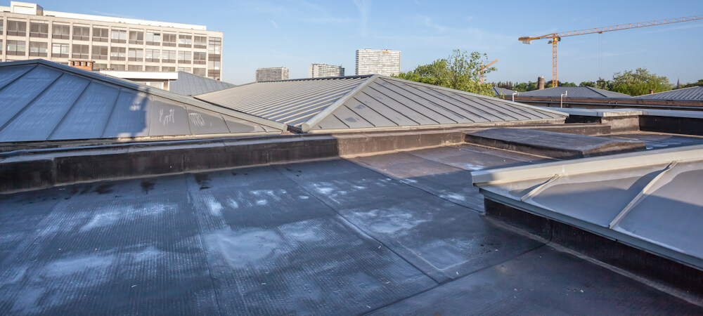 On a high building in the city there is cooling on a flat roof